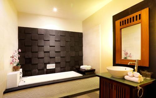 a bathroom with a sink and a bath tub at The Bali Bliss Villa in Seminyak