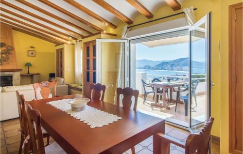 a dining room with a table and a view of the ocean at 2 Bedroom Cozy Home In Faro De Cullera in Faro de Cullera