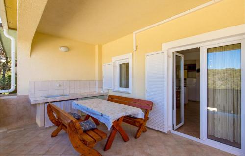 a patio with a table and chairs on a porch at 2 Bedroom Nice Apartment In Potocnica in Potocnica