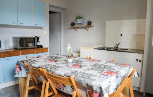 a kitchen with a table with a table cloth on it at Lovely Home In Sant Petru Di Tenda in Santo-Pietro-di-Tenda
