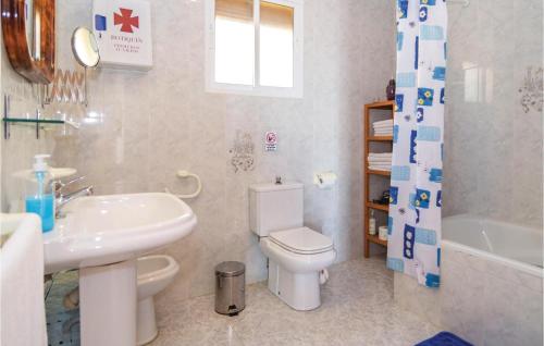 a bathroom with a sink and a toilet and a tub at Amazing Home In Torrox With 3 Bedrooms, Wifi And Outdoor Swimming Pool in Torrox