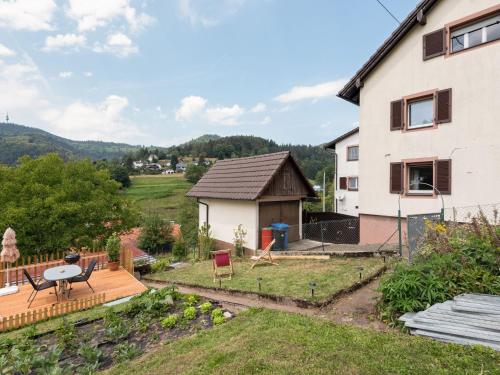 a view of a house with a deck and a yard at Apartment in Malsburg Marzell with private garden in Marzell
