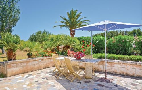 a table with an umbrella and chairs on a patio at Lovely Home In Alcúdia in Alcudia