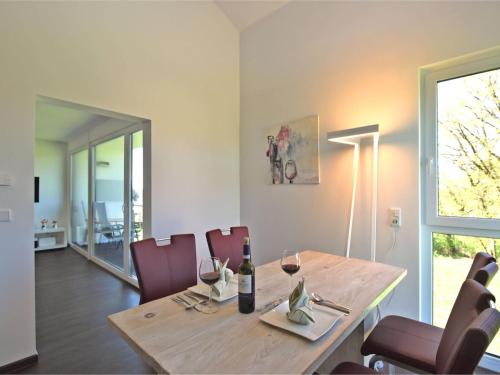 a dining room with a table with wine glasses at Apartment near the forest in Kammerstein