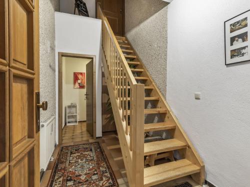 a wooden staircase in a home with a rug at Ferienwohnung, Schönsee in Schönsee