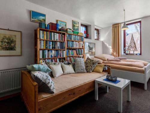 a room with a couch and a book shelf with books at Flat in Meldorf next to the town centre in Meldorf