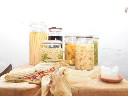 a wooden table with jars of vegetables and pasta at Escape Near River, Wolfsberg in Wolfsberg
