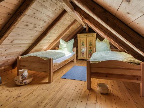 two beds in a room in a attic at Cosy holiday home in Bardolino with swimming pool in Wolfsberg