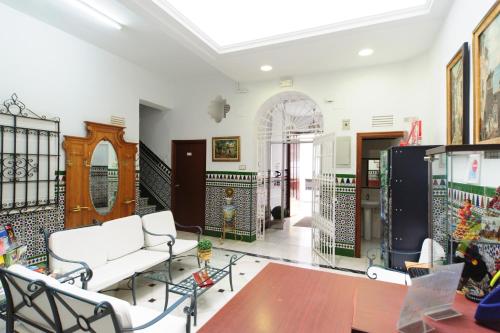
a kitchen filled with furniture and appliances at Pension Gala in Seville
