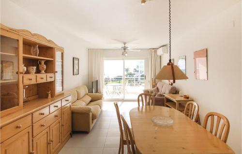 a kitchen and living room with a table and a couch at Awesome Apartment In Altea With Wifi in Altea