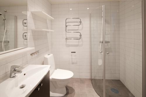 a bathroom with a toilet and a glass shower at Funäs Ski Lodge in Funäsdalen