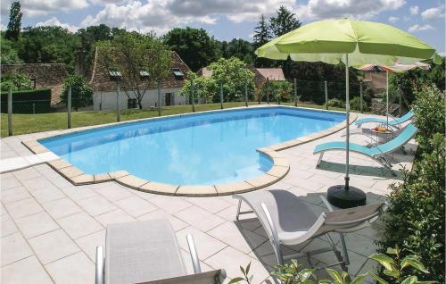 a swimming pool with chairs and an umbrella at Chouchou, Le Bourg in Laveyssière