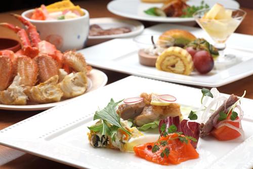 a table with three plates of food on it at Hotel Mahoroba in Noboribetsu