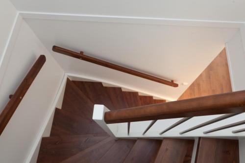 a staircase with wooden railings in a house at Funäs Ski Lodge in Funäsdalen