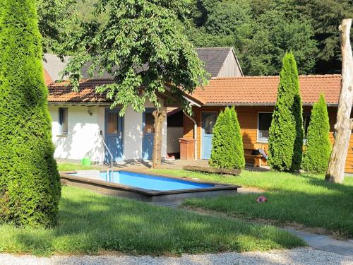 a house with a swimming pool in the yard at Charming apartment with private terrace in Bad Wildungen