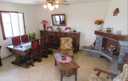 un soggiorno con tavolo e camino di 3 Bedroom Amazing Home In Valle Di Rostino a Casapitti