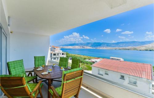 a balcony with a table and chairs and a view of the water at 2 Bedroom Beautiful Apartment In Pag in Pag