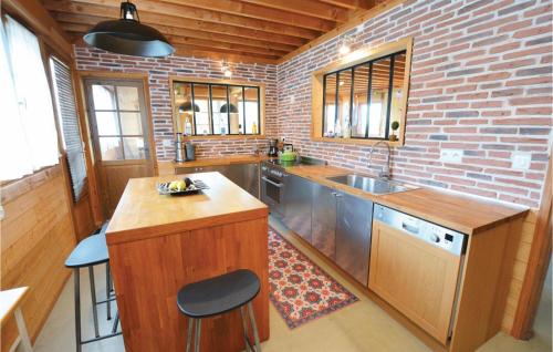 a kitchen with a sink and a brick wall at Cozy Home In Thezan-Les-Béziers in Thèzan-lès-Béziers