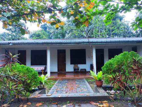 a house in the middle of a garden at Deer Garden Guest in Polonnaruwa