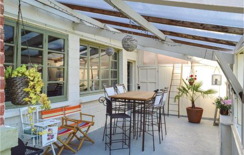 a patio with a wooden table and chairs at Beautiful Home In Fressin With Kitchen in Fressin