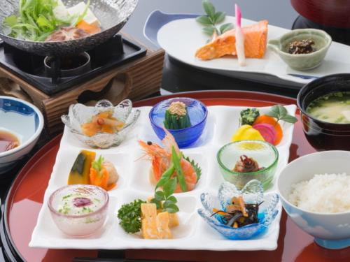 a table with plates of food and bowls of sushi at Kakureisen in Saga