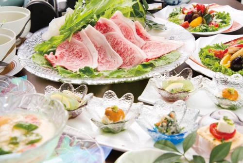 a table topped with plates of food on top thereof at Kakureisen in Saga