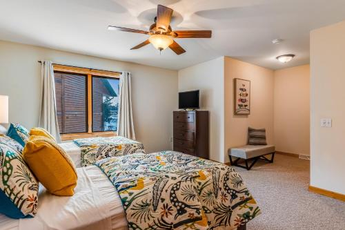 a bedroom with a bed and a ceiling fan at Lake Minocqua Lakeview in Minocqua