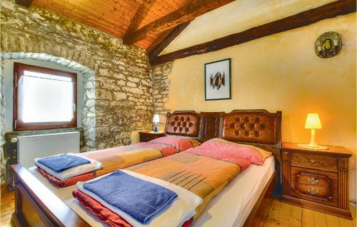 a bedroom with a large bed in a room at 2 Bedroom Stunning Home In Kastel in Kaštel