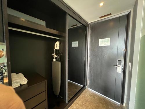 a shower with a glass door in a bathroom at The Shore Melaka in Melaka