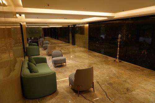 a lobby with a waiting room with couches and chairs at The Kings Park Grand-Near US Consulate in Chennai