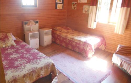 a bedroom with two beds and a lamp in it at Awesome Home In Campsegret in Campsegret