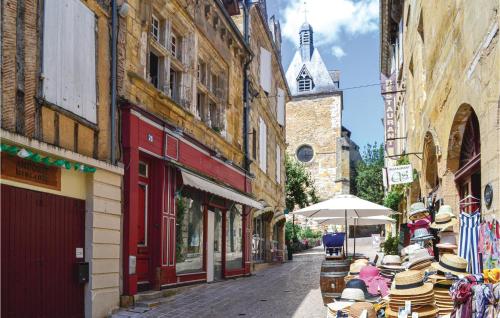 a street with tables and chairs on a street with buildings at Awesome Home In Campsegret in Campsegret