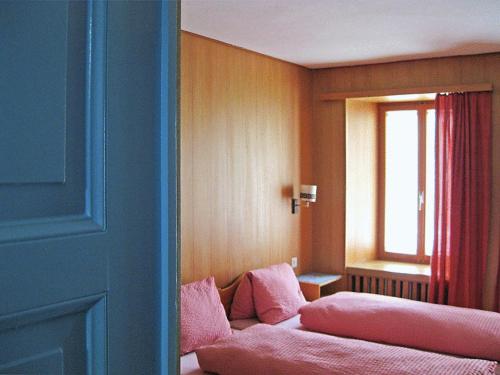 a room with a couch with a window and a window at Hotel-Gasthof Seehof Laax in Laax