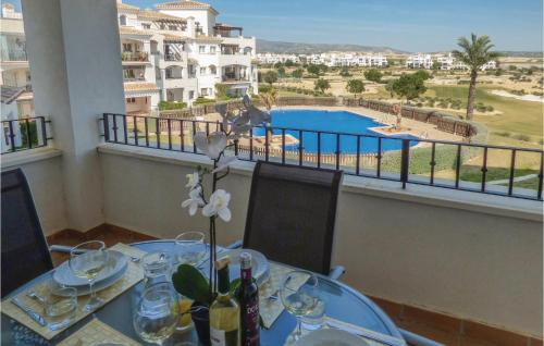 a dining table with a view of a pool at 2 Bedroom Gorgeous Apartment In Sucina in Sucina