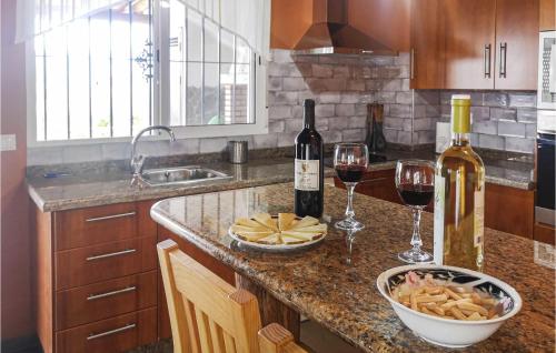 a kitchen with two glasses of wine and a bowl of cheese at Pet Friendly Home In Algatocin in Algatocín