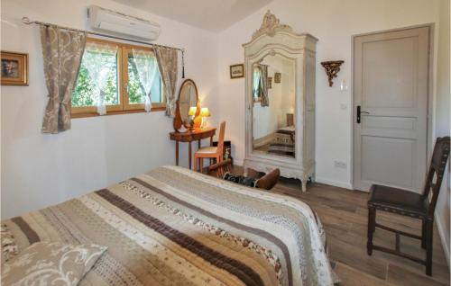 a bedroom with a bed and a mirror and a chair at Cozy Home In Saignon With Private Swimming Pool, Can Be Inside Or Outside in Saignon