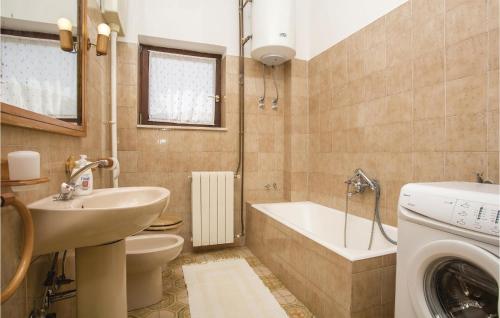a bathroom with a sink and a washing machine at Stunning Apartment In Lovran With 2 Bedrooms, Wifi And Outdoor Swimming Pool in Lovran