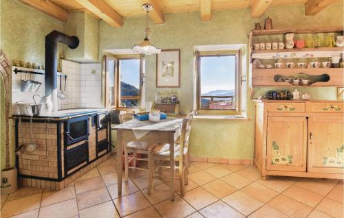 a kitchen with a stove and a table in it at Lovely Home In Lamon With Wifi in Lamon