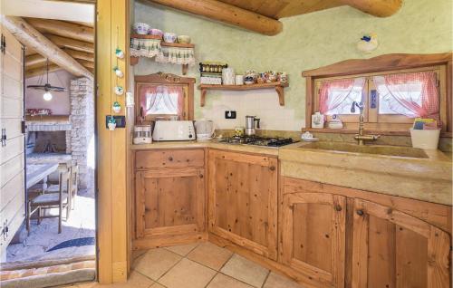 a kitchen with wooden cabinets and a sink at Lovely Home In Lamon With Wifi in Lamon