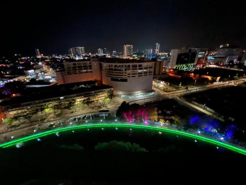 a night view of a building with green lights at The Shore Melaka in Melaka