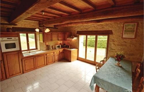 a large kitchen with wooden cabinets and a counter top at Stunning Home In La-Chapelle-Saint-Jean in La Chapelle-Saint-Jean