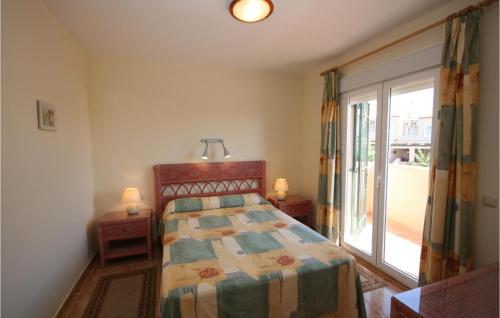 a bedroom with a bed and a large window at Jarales Alpha in Mijas Costa