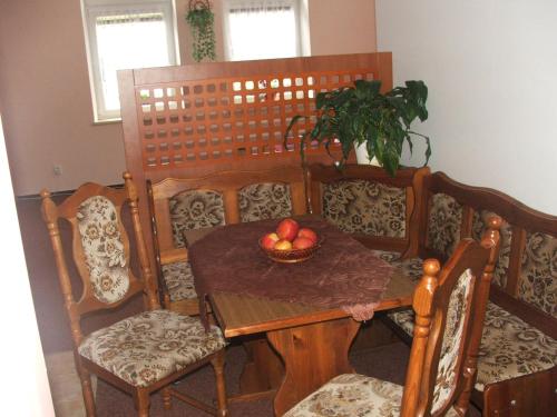 a table and chairs with a bowl of fruit on it at Ala ubytovani in Josefuv dul