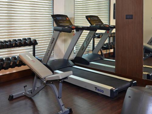 a row of treadmills in a gym at Residency Sarovar Portico in Mumbai