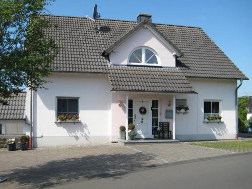 a white house with a window and a door at House with interior and garden in Volcanic Eifel in Strotzbüsch
