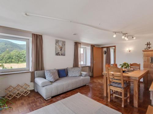 a living room with a couch and a table at Apartment in Malsburg Marzell with private garden in Marzell