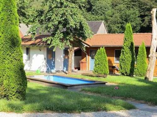a house with a swimming pool in the yard at Wohnung mit eigener Terrasse in Hüddingen in Bad Wildungen