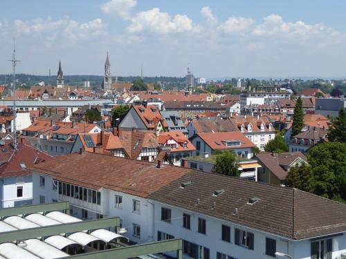 a view of a city with buildings and roofs at Hotel SiX in Kreuzlingen