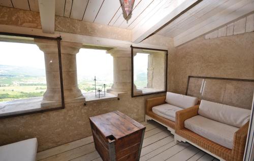 a room with a couch and a table and a window at 1 Bedroom Lovely Home In Viens in Viens