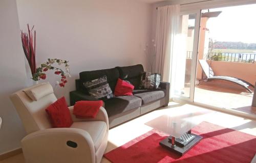a living room with a couch and a glass table at Stunning Apartment In Torre-Pacheco in Los Martínez